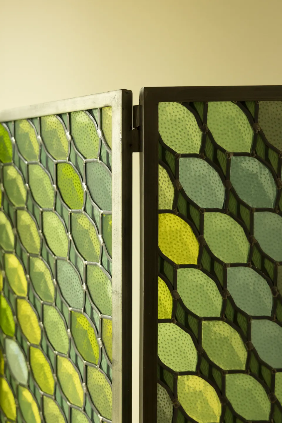 Close-up of textured green and yellow leaf-shaped tiles
