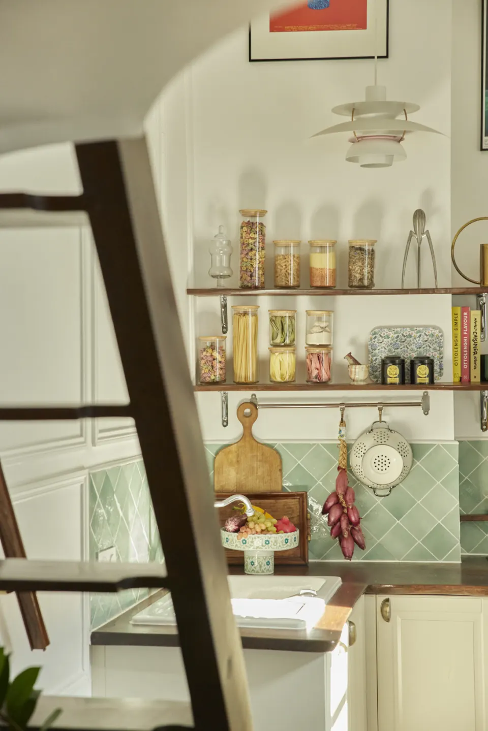 Kitchen shelves, jars and green tiled splashback